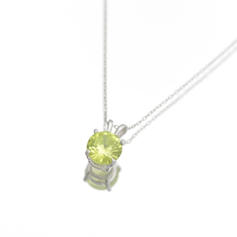 Peridot Necklace - A round silver solitaire Peridot pendant necklace, set in a sturdy sterling silver bail with a sterling silver necklace. A stone that gleams.