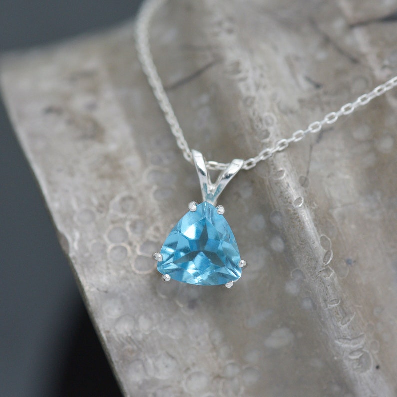 Blue Topaz Pendant. The stone is set in a sturdy sterling silver bail with a sterling silver necklace.