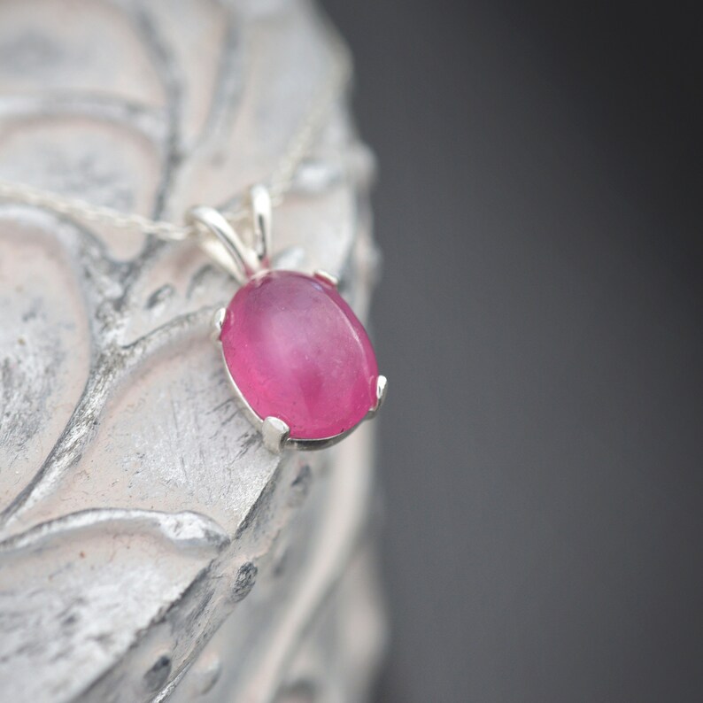 A delightful pink Ruby pendant set in a sturdy sterling silver bail with a fine trace sterling silver necklace