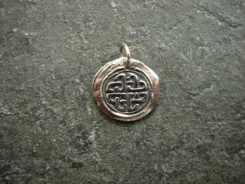 May include: Silver pendant featuring a Celtic knot design. The pendant is round and has a textured finish.