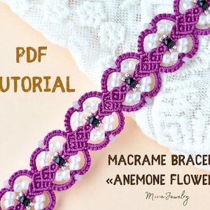 May include: PDF tutorial for a macrame bracelet with anemone flower design. The bracelet is made with purple cord and white beads, and features black beads in the center of each flower.