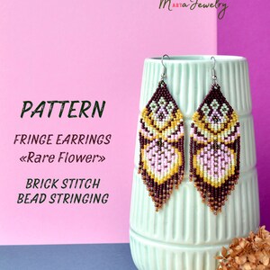 May include: A pattern for fringe earrings with a "Rare Flower" design. The earrings are made with brown, pink, and yellow beads and are strung using the brick stitch technique. The pattern is shown on a white vase with a brown and white vase in the background.
