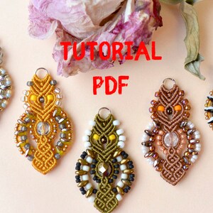 May include: Four beaded earrings with a macrame design in yellow, green, brown, and white. The earrings are on a light pink surface with the text "TUTORIAL PDF" in red.