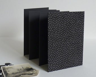 Accordion photo album, 12.5x17.5 cm, 14 black pages. Nepalese paper, mini white polka dots on a black background