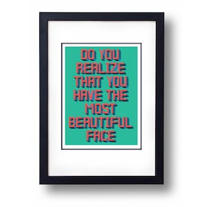 May include: Framed print with a teal background and red text that reads "Do you realize that you have the most beautiful face."