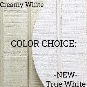 May include: Two wood samples showing different shades of white paint. The left sample is labeled "ORIGINAL - Creamy White" and the right sample is labeled "NEW - True White". The text "COLOR CHOICE" is displayed in the center of the image.