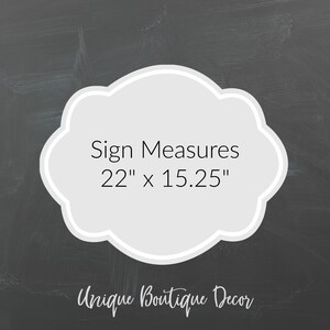 May include: A white sign with a gray cloud shape and black text that reads "Sign Measures 22" x 15.25" and "Unique Boutique Decor".