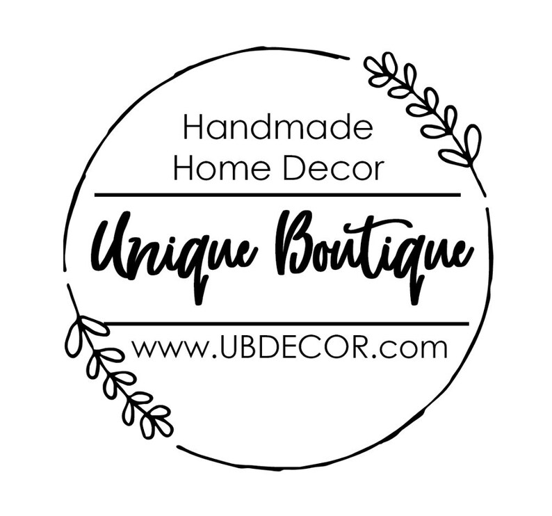May include: Black and white logo with a circle border and floral accents. The text reads "Handmade Home Decor Unique Boutique www.UBDECOR.com"