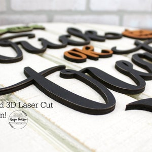 May include: A 3D laser cut wooden sign with the words "Trick or Treat" in black with a distressed finish. The sign is decorated with orange and brown pumpkins and a black bat.