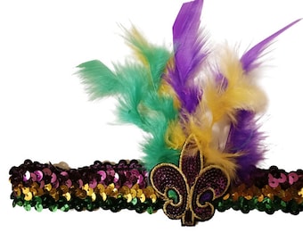 May include: A Mardi Gras headband with green, purple, and gold feathers, a sequined fleur-de-lis, and a sequined band in the same colors.