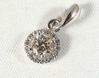 Beautiful gold colored round cut diamond pendant with chain enhanced with brilliant cut white diamonds stamped 14K and 18K fine jewelry