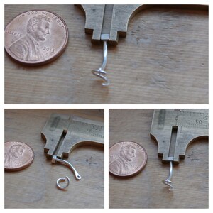 May include: A close-up of a silver earring with a hook closure and a small, coiled wire detail. The earring is measured against a penny for size comparison.