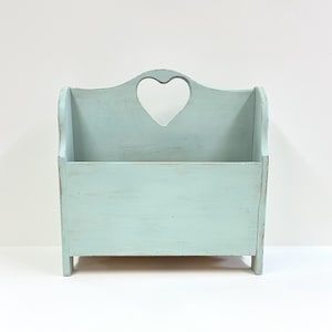 Vintage wood magazine rack and book holder with heart shaped cutout and painted a light aqua blue