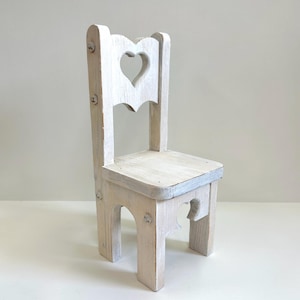 Vintage wooden doll chair with heart cutout for displaying dolls, bears, or plants