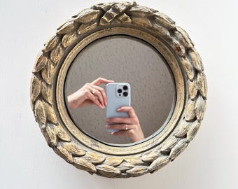 Vintage 10" round mirror with carved laurel leaf wreath design
