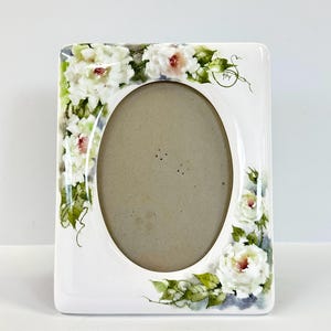 Vintage ceramic oval photo frame with hand-painted floral designs