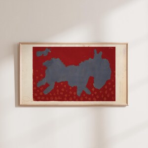 May include: A framed abstract painting with a blue silhouette of a creature on a red background with small red dots.