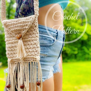 May include: A beige crochet crossbody bag with a flap closure, wooden button, and fringe detailing. The bag has a long strap and decorative wooden beads. The words "Crochet Pattern" are in a circle on the image.
