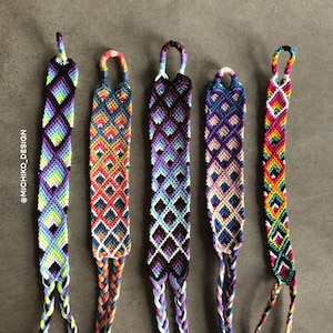 May include: Five colorful friendship bracelets with a diamond pattern. The bracelets are made with different colored threads and have a loop at the top.