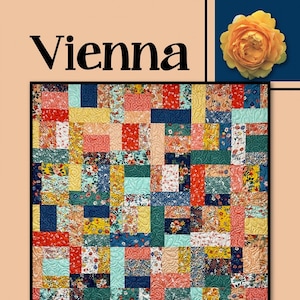 May include: A quilt pattern called "Vienna" by Villa Rosa Designs. The quilt is made up of colorful squares in shades of red, yellow, blue, green, and pink. The squares are arranged in a random pattern, creating a visually appealing and modern design.