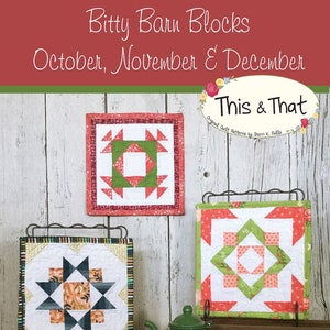 May include: Three small, framed quilt blocks with geometric designs in red, green, and white, displayed on a wooden shelf. A small green teapot sits in front of the blocks. The text "Bitty Barn Blocks" and "October, November & December" is visible.