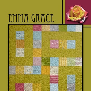 May include: A quilt pattern called "Emma Grace" by Villa Rosa Designs. The quilt is made of a variety of colorful fabrics with floral and geometric patterns. The quilt is quilted in a swirling pattern.