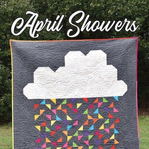 May include: A quilt pattern called "April Showers" featuring a white cloud with a gray background and a colorful rain design. The quilt is made by Running Doe Quilts for Villa Rosa Designs.