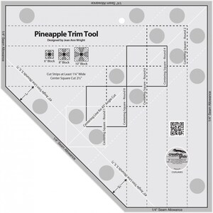 May include: A gray and white Pineapple Trim Tool with the text "Pineapple Trim Tool" and "Designed by Jean Ann Wright". The tool includes markings for 6", 8", and 10" blocks, along with cutting guides and seam allowances for quilting projects.