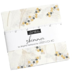 May include: A white fabric square with a gold and gray shimmer pattern. The fabric is labeled "shimmer by Brigitte Heitland for ZEN CHIC".