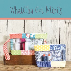 May include: Two patchwork fabric mini pouches, one with toiletries and the other with sewing supplies, sit on a wooden surface. The pouches have clear plastic windows and are labeled "WhatCha Got Mini's" and "This & That".