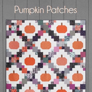May include: A quilting pattern called "Pumpkin Patches" with a white background and a patchwork design featuring orange pumpkins, black, white, and purple squares. The pattern is made with fat quarters, 5-inch squares, or 10-inch squares.