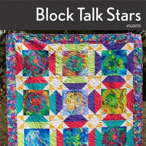 May include: A colorful quilt with a pattern of stars and sea creatures. The quilt is made with a variety of fabrics, including red, blue, green, yellow, and purple. The quilt is bordered with a fabric that has a pattern of bubbles. The quilt is titled "Block Talk Stars" and is made by Swirly Girls. The text "Pattern adjusts for ANY panel, block or t-shirt!" is also included.
