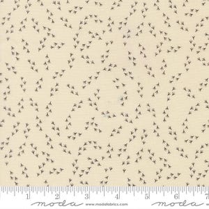 May include: Cream-colored fabric with a repeating pattern of small, dark gray bird tracks. The tracks are arranged in a scattered, flowing design across the fabric's surface. The fabric has a ruler along the bottom edge.
