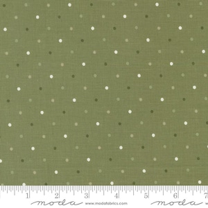 May include: Close-up of olive green fabric with a repeating pattern of small, evenly spaced polka dots in shades of white, gray, and dark green. The fabric has a textured appearance. A ruler is at the bottom of the image.