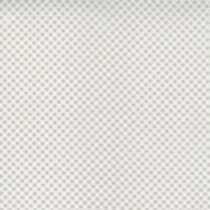 May include: A close-up of a fabric with a repeating pattern of small, light brown squares on a white background. The squares are evenly spaced, creating a grid-like design. The fabric has a slightly textured appearance.