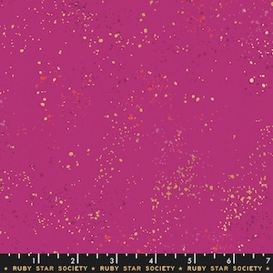 May include: A vibrant magenta fabric with a speckled pattern of gold, orange, and purple dots. The fabric has a smooth texture and is suitable for various sewing projects. The text "RUBY STAR SOCIETY" is printed along the bottom edge.