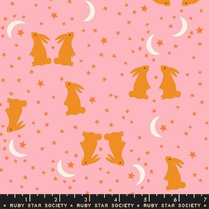 May include: Pink fabric with a repeating pattern of orange bunnies, stars, and crescent moons. The bunnies are in various poses. The text "RUBY STAR SOCIETY" is at the bottom.
