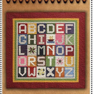May include: A colorful mini alphabet quilt with letters A through Z, each in a different square. The quilt is 42.5 inches by 42.5 inches. The text "Primitive Gatherings" is at the top.