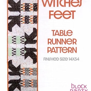 May include: A Witches Feet table runner pattern by Block Party Quilt Co. The rectangular quilt features black, white, and orange geometric shapes and spiderweb motifs. The text reads Witches Feet Table Runner Pattern, Finished Size 14x54.