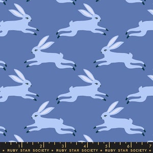 May include: A repeating pattern of light blue rabbits in a running pose on a dark blue background. The rabbits have long ears and black feet. The text "RUBY STAR SOCIETY" is at the bottom.