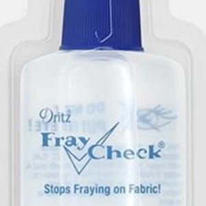May include: A clear plastic bottle of Dritz Fray Check with a blue cap. The label reads "Fray Check" and "Stops Fraying on Fabric!" The bottle contains 0.75 fl oz (22 ml) of liquid.