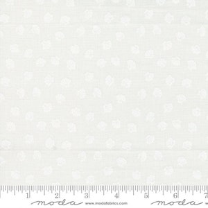 May include: A white ceramic mug with a black handle and the text "But First, Coffee" in a bold, black font. The mug is filled with a dark liquid, likely coffee, and sits on a light-colored surface.