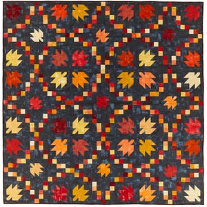 May include: A quilt with a dark blue background featuring a repeating pattern of orange, red, and yellow maple leaves. The leaves are arranged in a symmetrical pattern with a border of small squares in various shades of orange, red, and yellow.