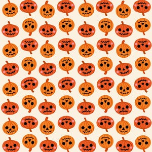 May include: A repeating pattern on a light cream background featuring orange pumpkins with black jack-o'-lantern faces. Each pumpkin has two round black eyes, a small triangular nose, and a jagged stitched mouth with pink circular cheeks.