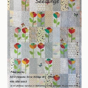 May include: A colorful patchwork quilt titled "Seedlings" featuring stylized flower designs. The quilt has a variety of patterned squares in shades of gray, beige, and white. The flowers are in red, orange, yellow, and teal. The quilt is made by Fiberworks.