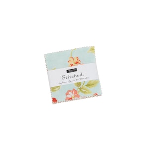 May include: A stack of pre-cut fabric squares with a floral pattern in shades of red, yellow, and green on a light blue background. The fabric is wrapped with a white label that reads "Stitched." by Joanna Figueroa & Fig Tree & Co.
