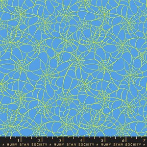 May include: Blue fabric with a repeating pattern of yellow spiderwebs. The design is a seamless repeat, creating a dense network of webs across the surface. The fabric is suitable for various crafting projects.