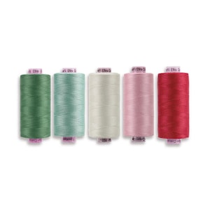 May include: Five cylindrical spools of thread arranged in a horizontal row. The colors from left to right are forest green, sage green, light cream, soft pink, and deep red. Each spool features a pink label at the top and bottom with text.