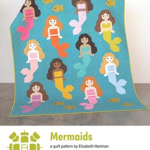 May include: A turquoise quilt featuring a repeating pattern of mermaids and yellow fish. The mermaids have various skin tones, hair colors, and tail colors. The quilt is labeled "Mermaids" and is a quilt pattern by Elizabeth Hartman.