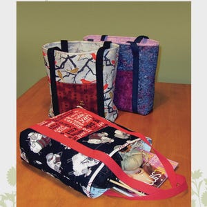May include: Three fabric tote bags with various patterns, including birds on branches, floral, and sheep. The bags have black or red handles and accents. The text "Sassy Soho Shopper" is at the bottom.